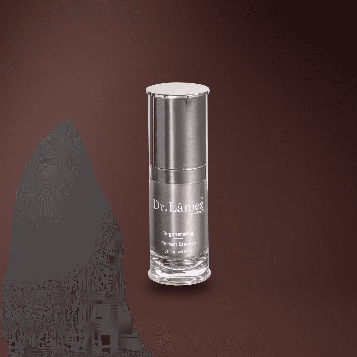 Graphite pump bottle of Regenerating Perfect Essence, 35 ml, lit on a warm plum studio backdrop.